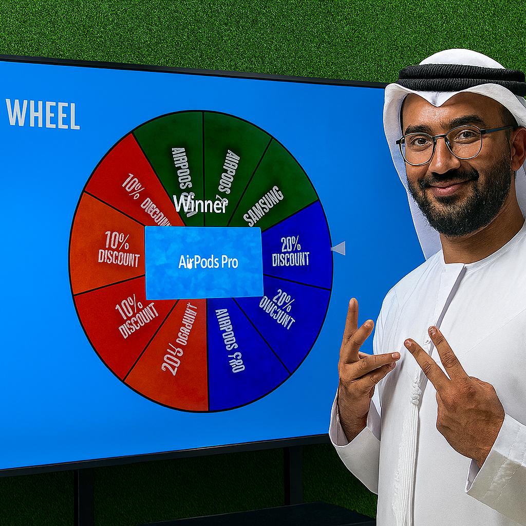 Arab male playing Spin the Wheel game at an exhibition event in Dubai, wearing traditional kandura, fully branded setup with digital screen and prize display, engaging crowd.